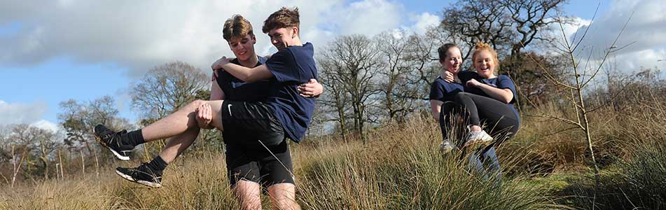 Students carrying each other